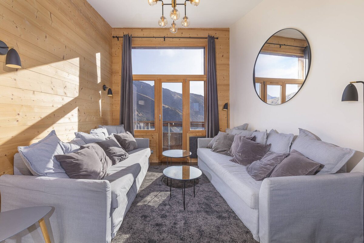 A living room with a couch and two tables