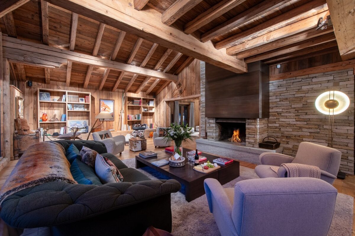 A living room with a couch and chairs and a fireplace