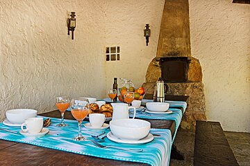 A table set for a meal with bowls and glasses of orange juice