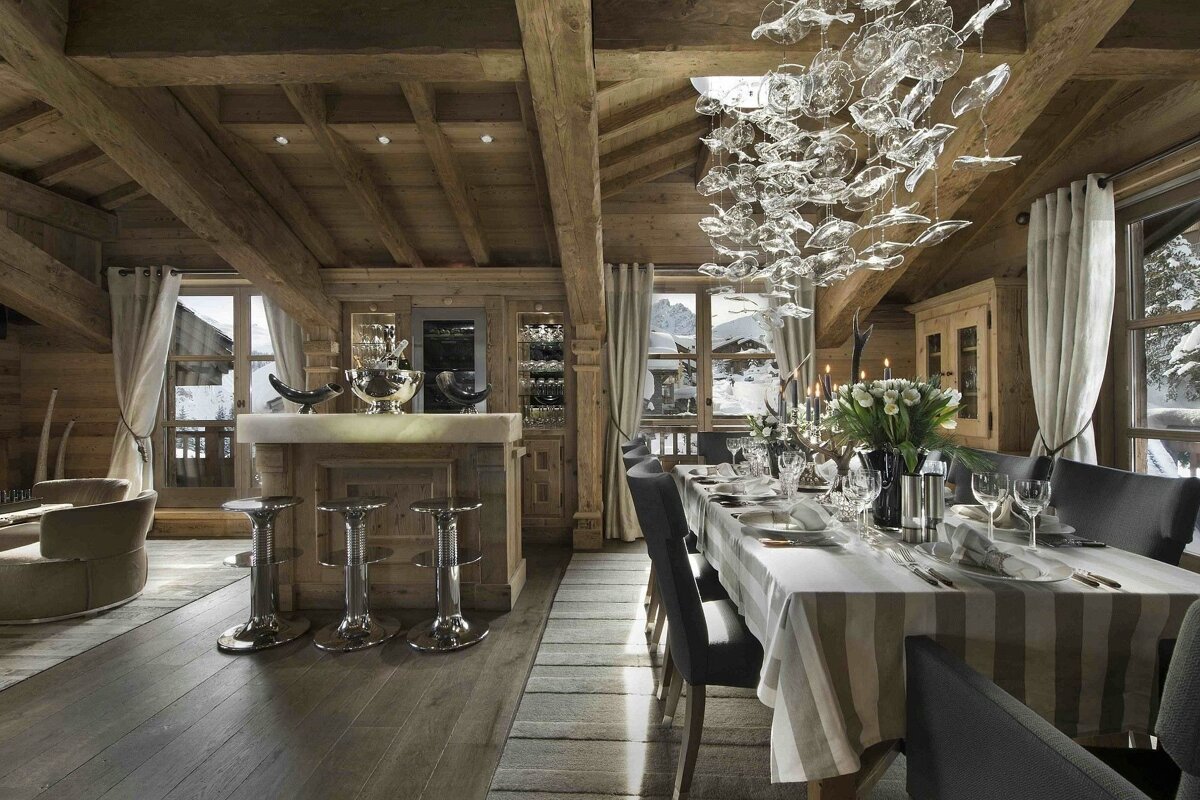 A dining room with a long table and chairs