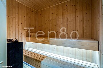 A wooden sauna with the word ten80 on the wall