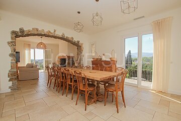 A dining room with a table and chairs and the word home on the wall