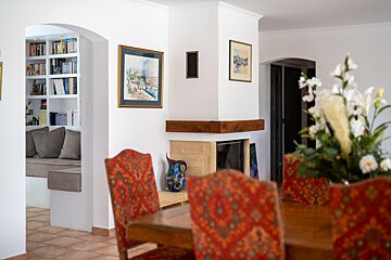 A room with a fireplace and a painting on the wall