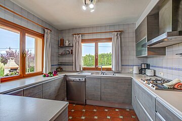 A kitchen with stainless steel appliances and wooden cabinets