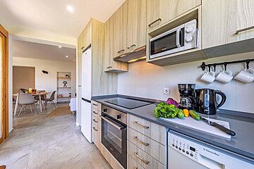 A kitchen with an electrolux dishwasher and a microwave