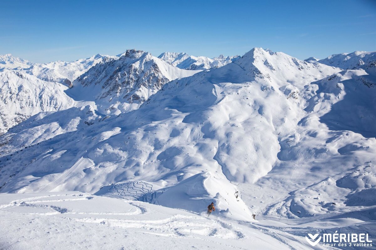 A snowy mountain with the word meribel on the bottom