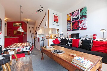 A living room with a painting of marilyn monroe on the wall