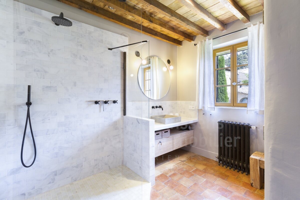 A bathroom with a sink and a shower with the word mobilier on the wall