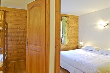 A bedroom with a king size bed and bunk beds