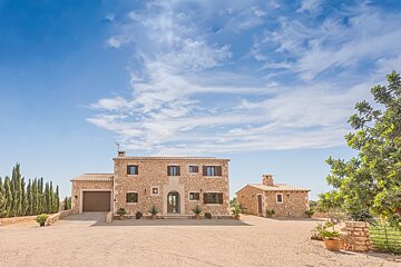 A large stone house with a garage in front of it