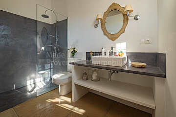 A bathroom with a sink and a toilet and the words made in provence on the wall