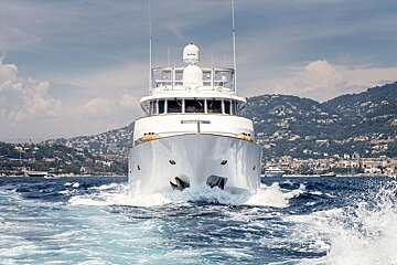 A white boat with a radar on the top of it