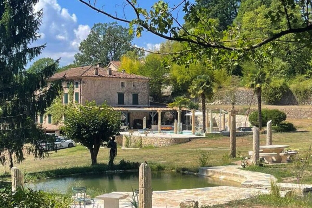 A large house with a swimming pool in front of it