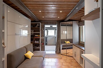 A living room with a couch and a mirror
