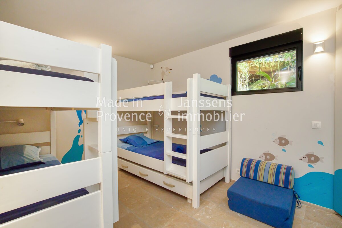 A bunk bed in a room with the words made in provence on the wall