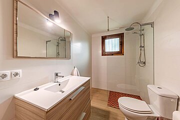 A bathroom with a toilet a sink and a mirror
