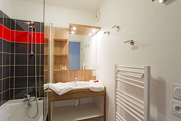 A bathroom with a sink and a towel rack