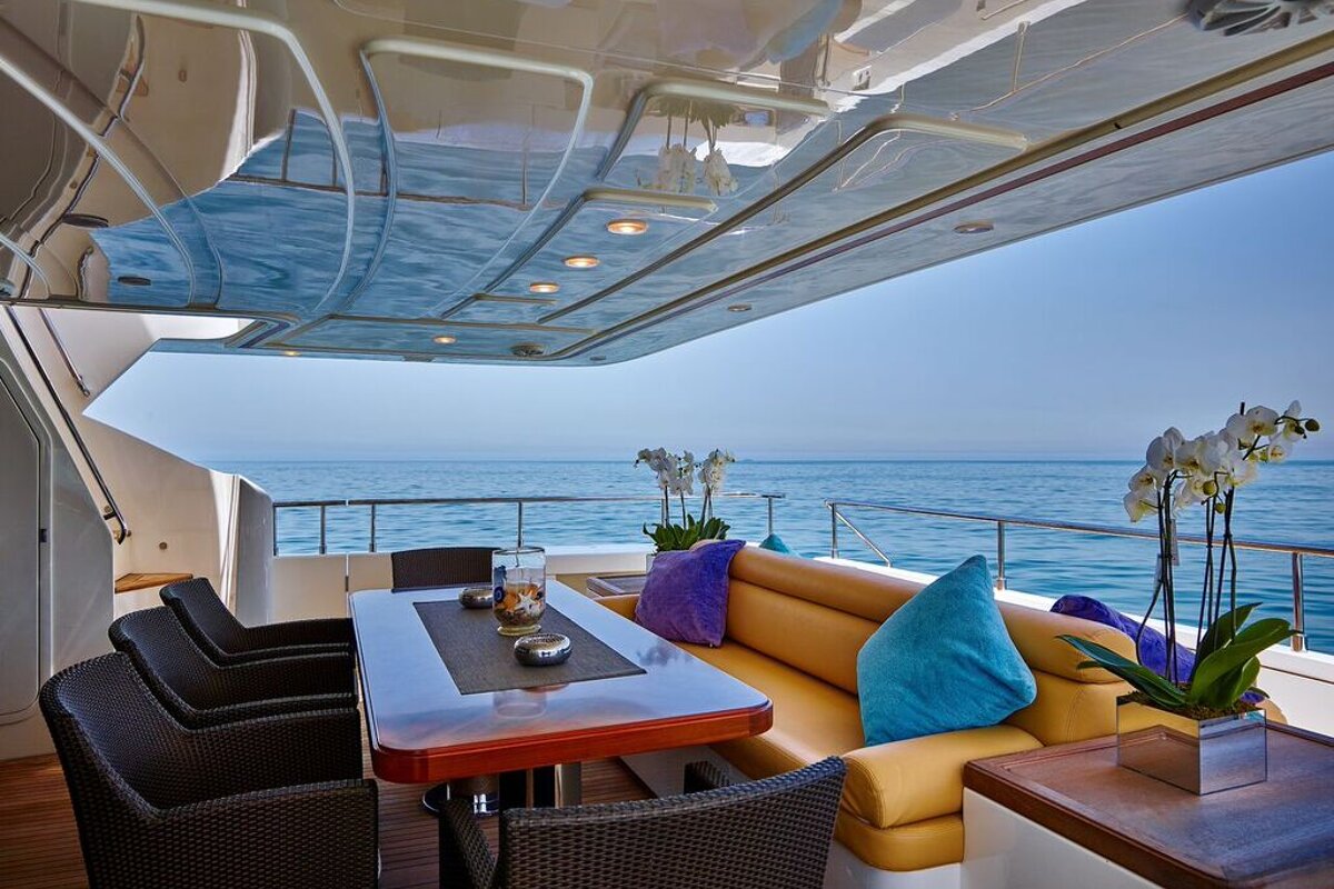 A boat with a table and chairs looking out over the ocean