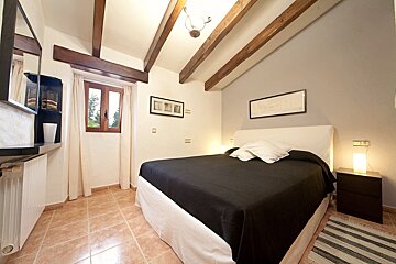 A bedroom with a large bed and a window