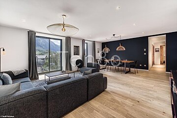 A living room with a couch and a table with the word tc on the wall