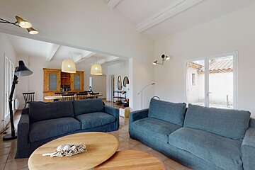 A living room with a blue couch and a wooden table