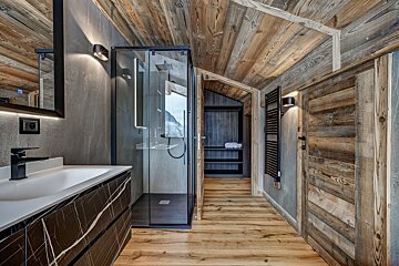 A bathroom with a sink and a walk in shower