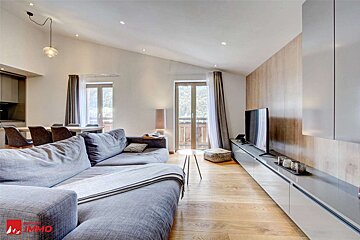 A living room with a couch and a flat screen tv