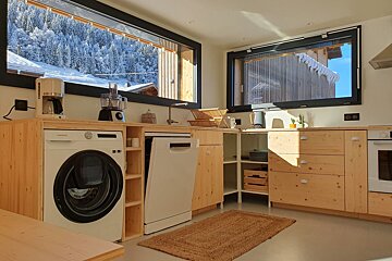 A kitchen with a samsung washing machine and dishwasher