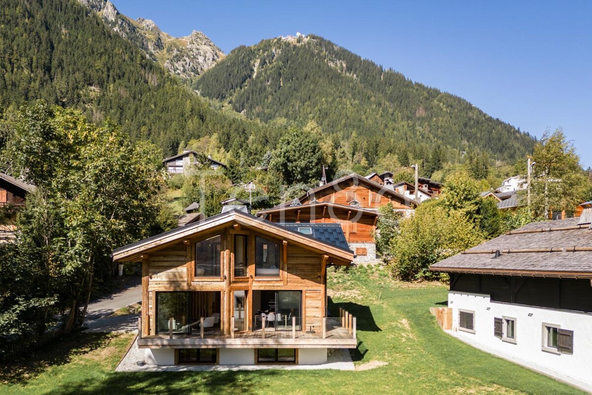 A wooden house with a mountain in the background