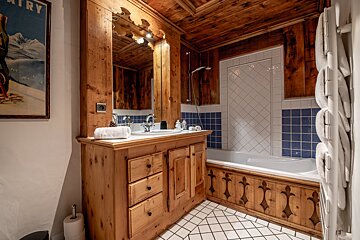 A bathroom with a picture on the wall that says country