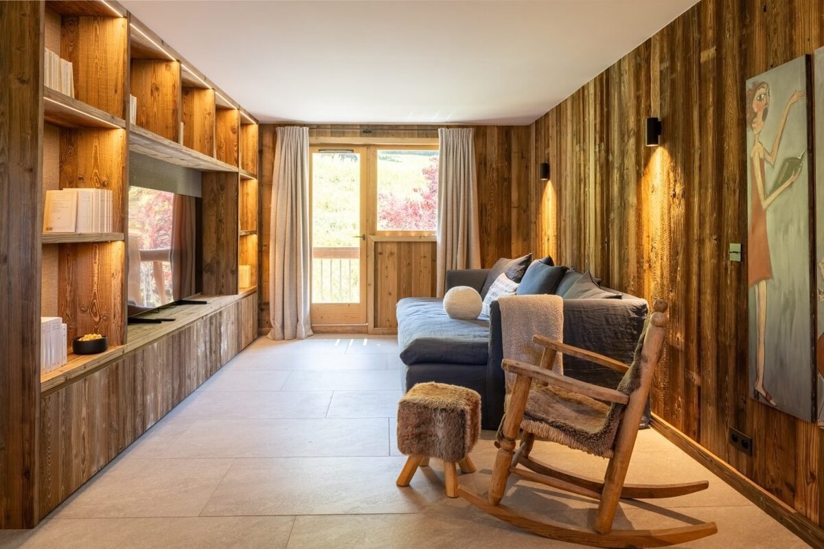 A living room with a couch and a rocking chair