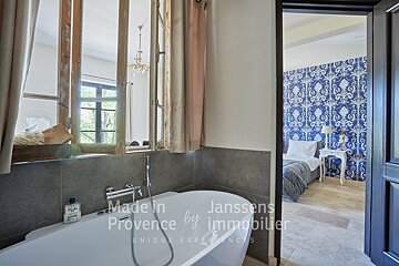 A bathroom with a bathtub and the words made in provence by immobilier