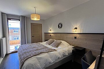 A bedroom with a sign on the wall that says 16
