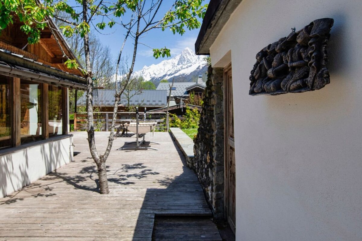 A wooden deck with a mountain in the background