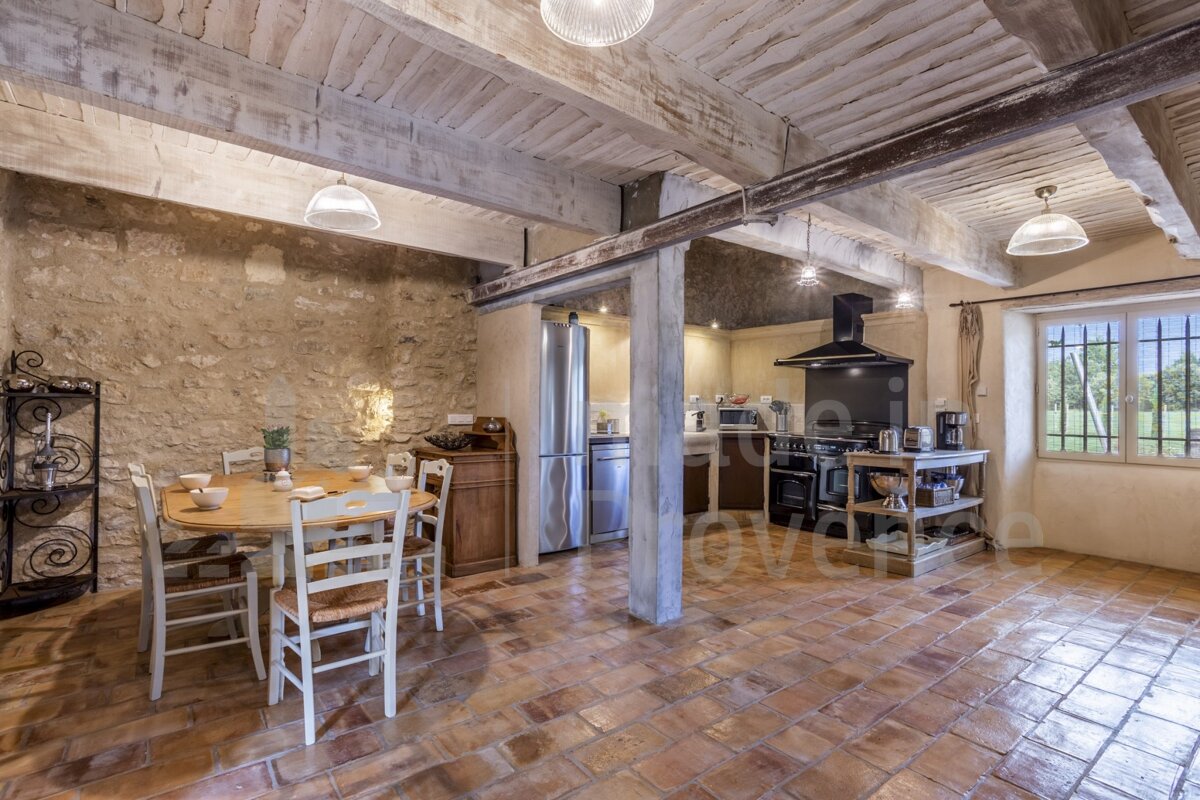 A kitchen with a table and chairs and a stove