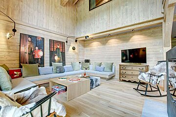 A living room with a couch and a rocking chair