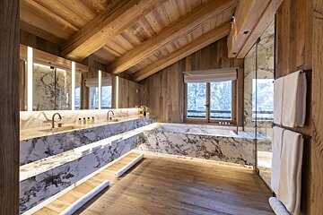 A bathroom with marble counter tops and a bathtub