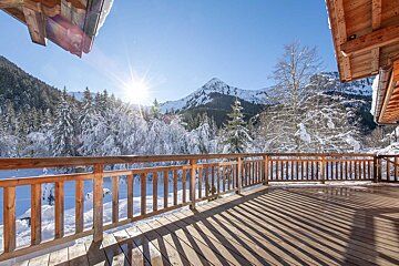 A wooden deck with a mountain in the background