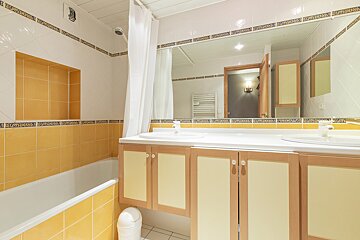 A bathroom with two sinks and a bathtub