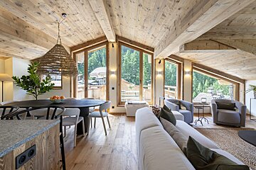 A living room with a couch a table and chairs