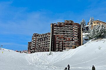 A large building with a lot of windows is covered in snow