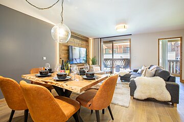 A living room with a dining table and chairs