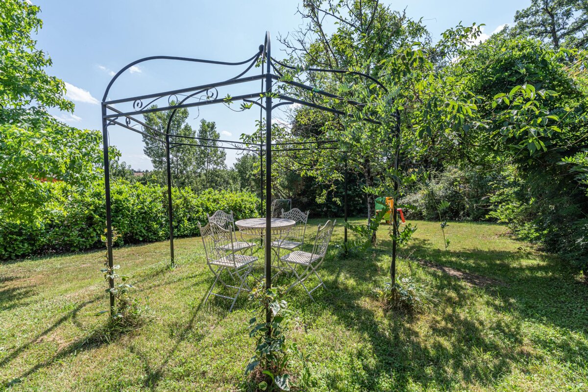 A gazebo with a table and chairs underneath it