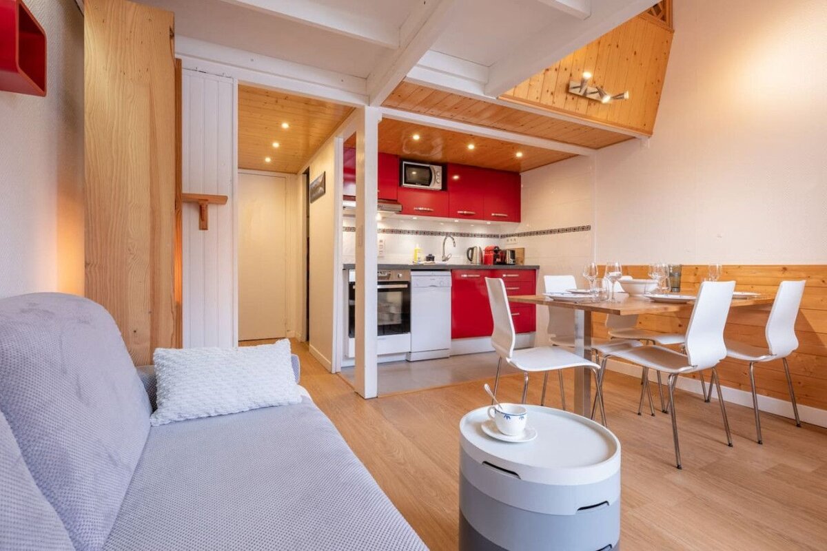 A living room with a couch and a table and chairs