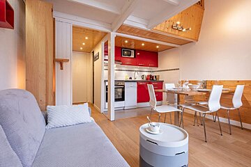 A living room with a couch and a table and chairs