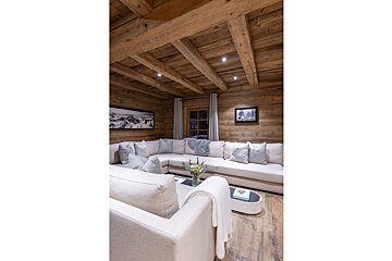 A living room with a sectional couch and a coffee table
