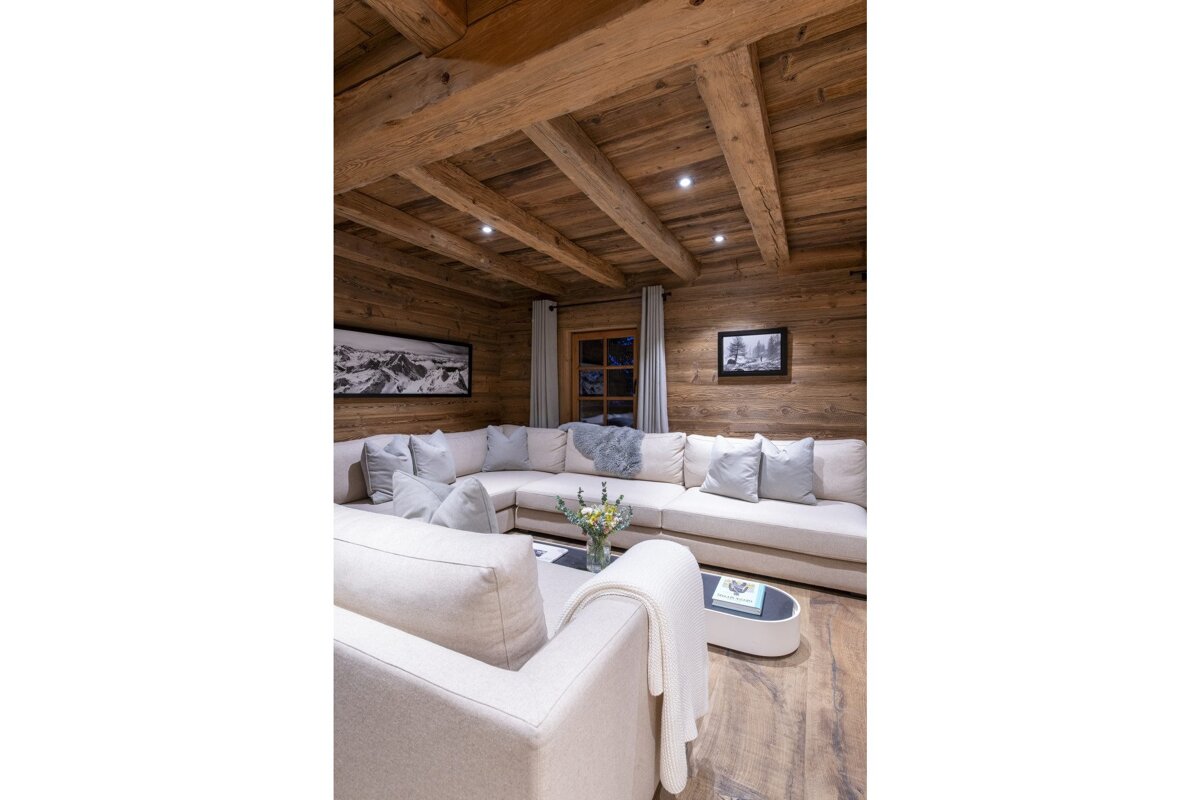 A living room with a sectional couch and a coffee table