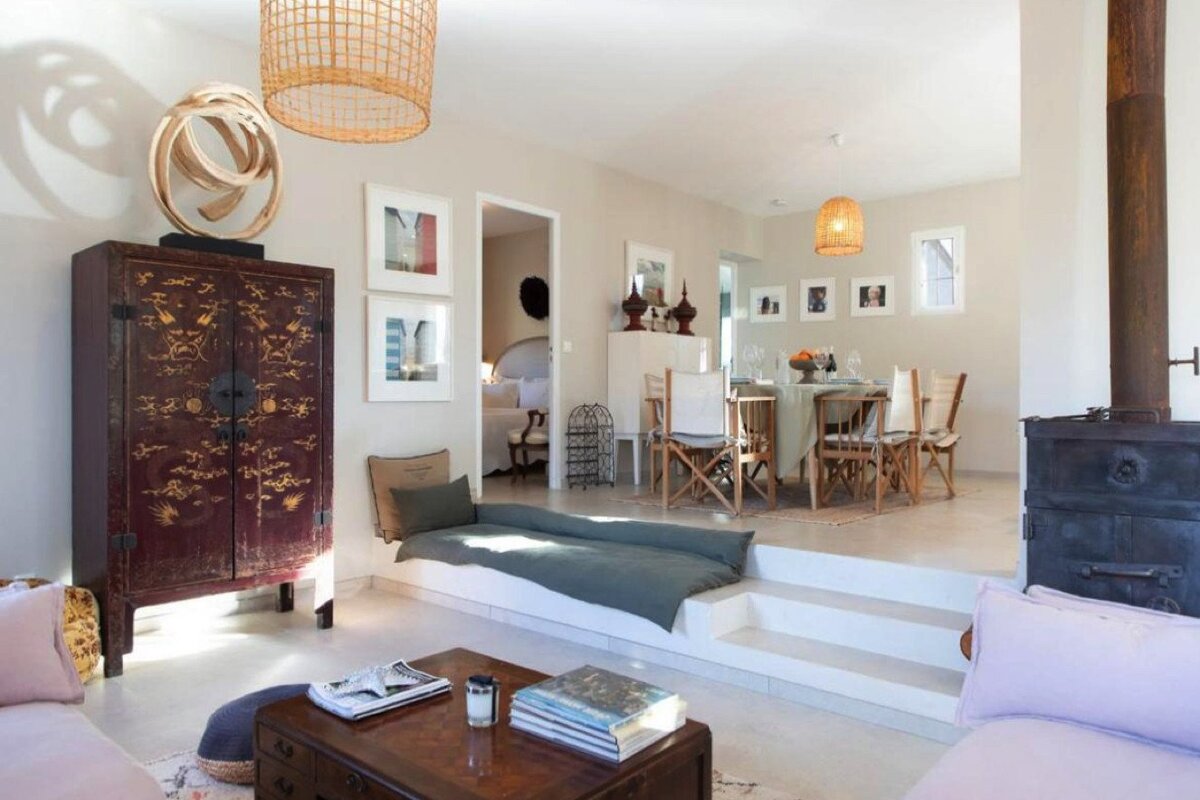 A living room with a pink couch and a red cabinet