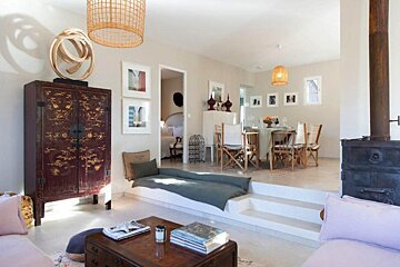 A living room with a pink couch and a red cabinet