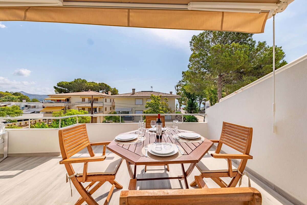A table with plates and a bottle of wine on it